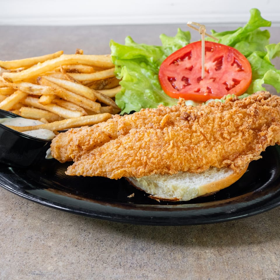 Fried flounder sandwich with fries.