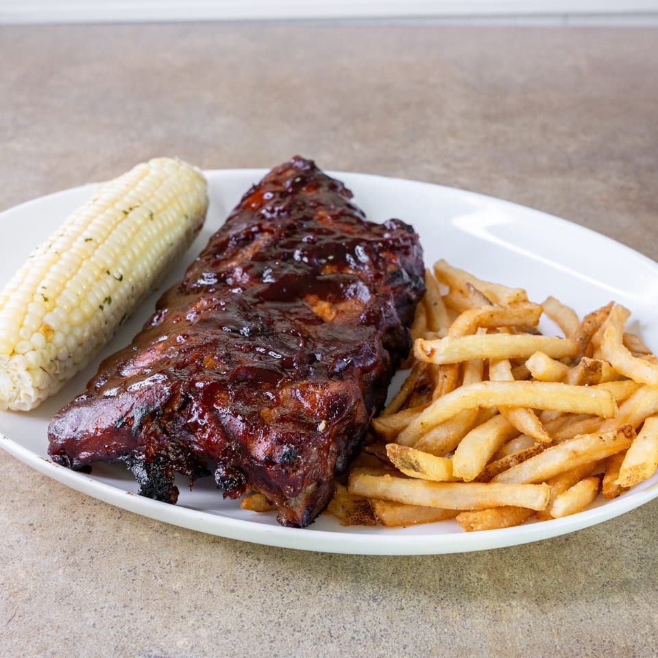 Barbecue ribs with corn and fries.